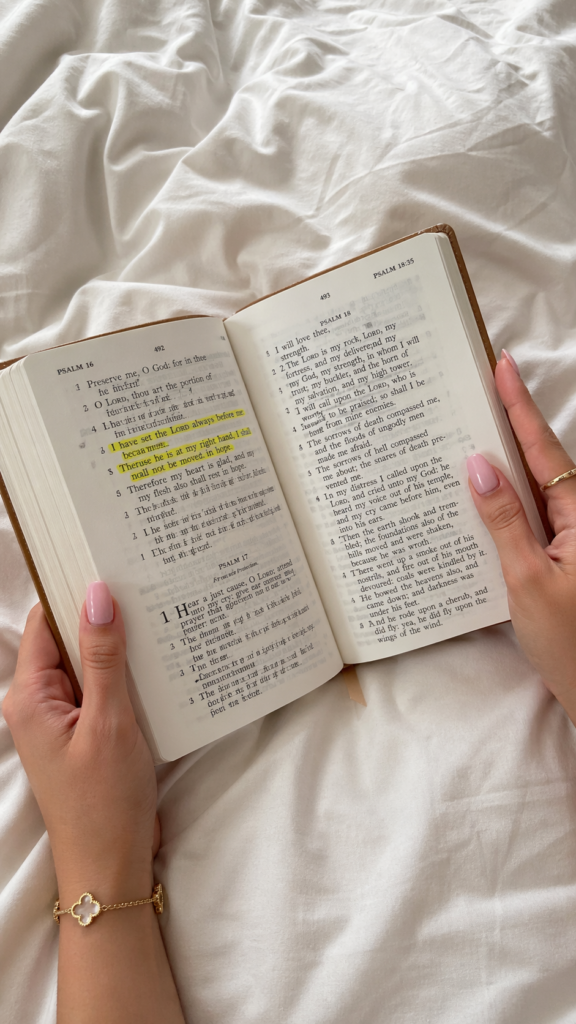 A woman is holding a bible open to Psalms and there are some verses highlighted.